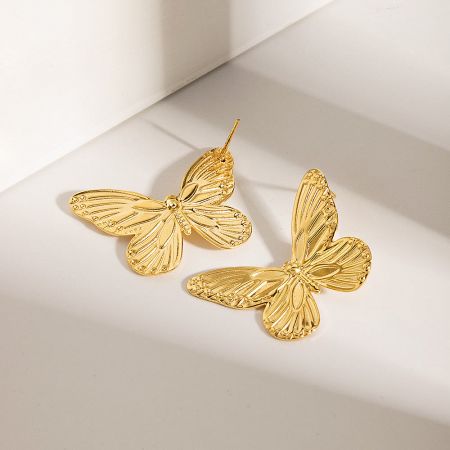A pair of gold butterfly stud earrings with intricate wing details on a clean white background.