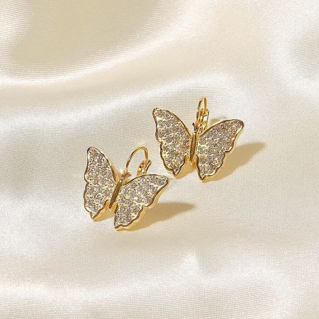 Front view of the stainless steel butterfly earrings with clear stones against a neutral backdrop.