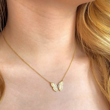 Model wearing the elegant gold butterfly pendant necklace to showcase its size and style.