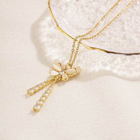 A beautiful gold butterfly necklace with sparkling crystal tassels, another design from the exclusive set.