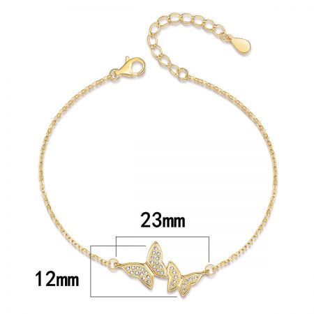 The gold butterfly bracelet showing the pendant dimensions, 23mm by 12mm.