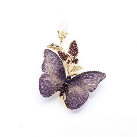 Angled view of the purple butterfly brooch showcasing its intricate embroidery and gemstone embellishments.