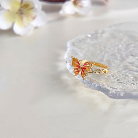 Another angle of the vibrant enamel butterfly ring, highlighting the gold finish.