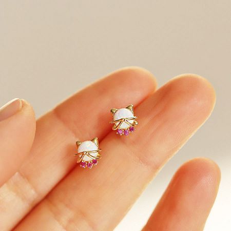 Gold cat earrings with white opal and pink gemstones.
