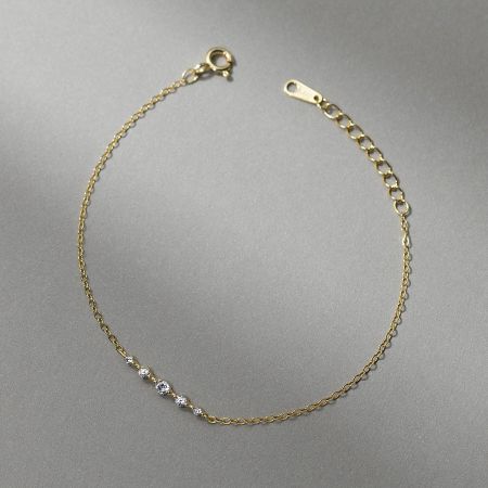 Another view of the gold-tone pavé bracelet, showing its delicate chain.