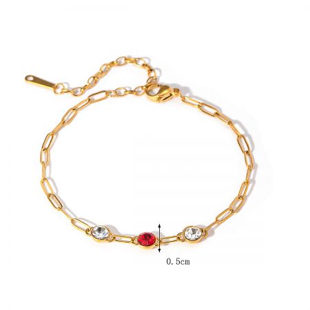 Gold-plated bracelet featuring red and clear cubic zirconia stones.