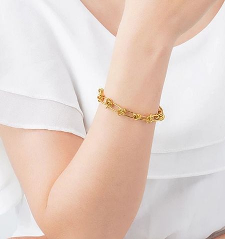 Model wearing the gold plated stainless steel bracelet to show its fit and style.