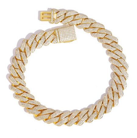 Close-up of a gold Cuban link chain bracelet with diamond detailing.