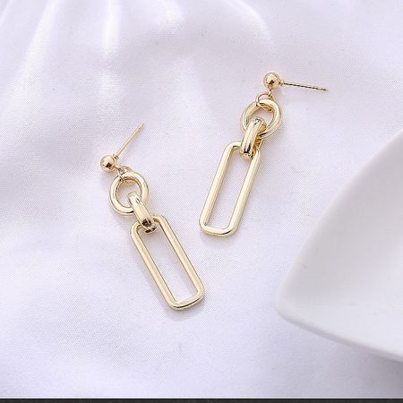 Detailed view of the rectangular and oval links of the earrings.