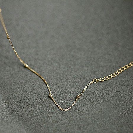 Product shot of the gold-plated bead chain bracelet against a white background.