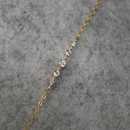Detailed view of a sterling silver chain bracelet with sparkling clear cubic zirconia stones.