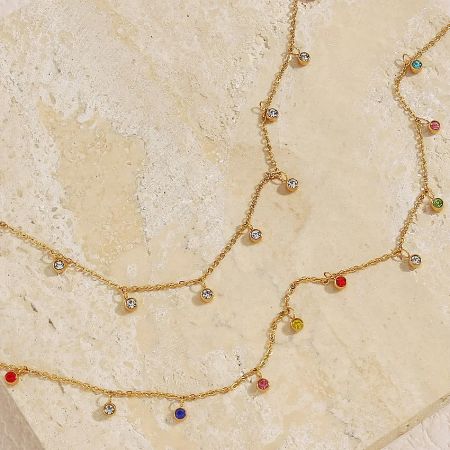 Detailed product shot of the multicolour zircon charm necklace on a white background.