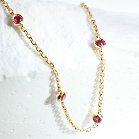 925 Sterling Silver Mini Ruby Cubic Zirconia Link Chain Bracelet - A delicate 925 sterling silver link chain bracelet, gold-plated and adorned with five brilliant mini ruby cubic zirconia stones, displayed on a neutral background.