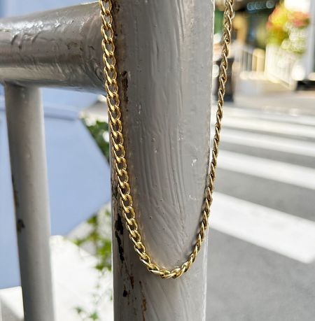 Detailed view of the gold chain necklace links.