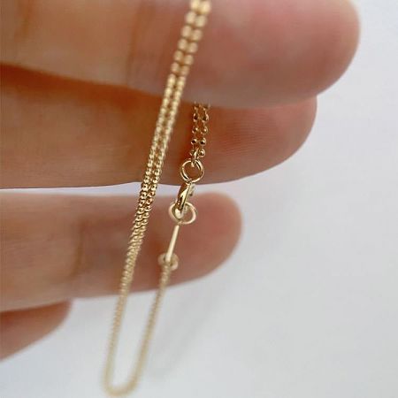 Product shot of the minimalist double layer beaded chain bracelet.