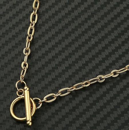 Detailed close-up of the gold chain and toggle clasp mechanism.