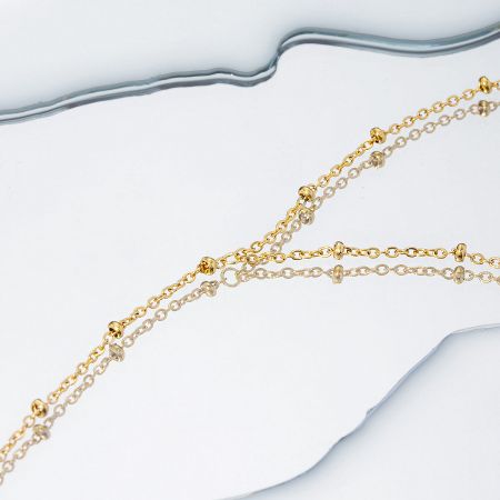Two gold-plated bead chain bracelets from the set displayed together to highlight the product offering.
