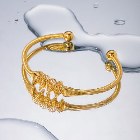 Detailed view of a Nordic style open cuff bangle featuring a coiled wire design.