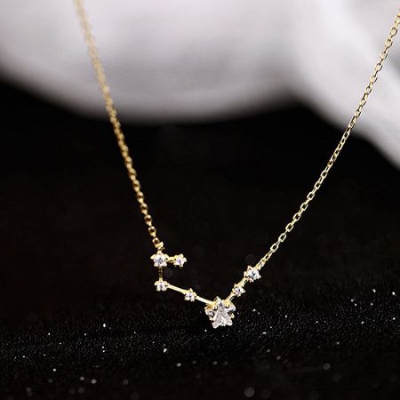 Close-up of the gold-plated sterling silver constellation necklace on a white background.