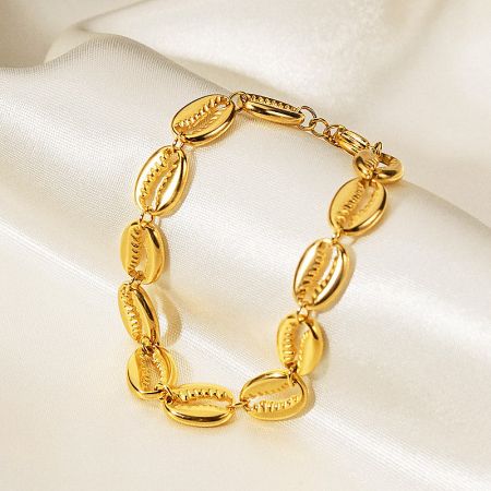 Gold bracelet with a cowrie shell design.