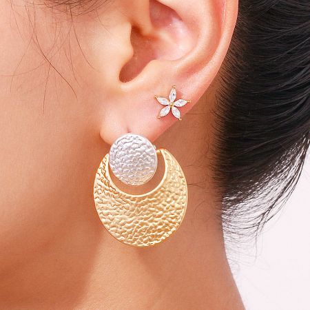 Stylish two-tone hammered earring shown with a complementary flower stud.