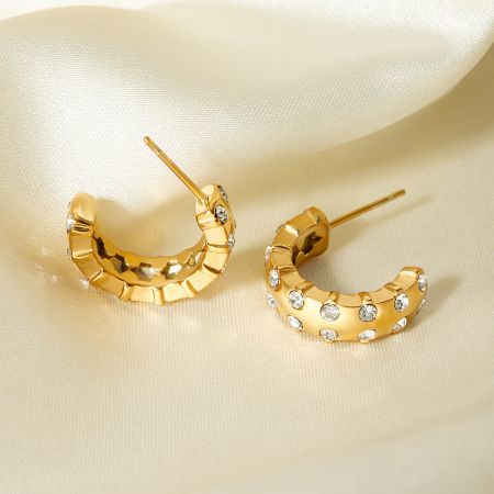 Front view of the gold crescent-shaped earrings showcasing the zirconia arrangement.