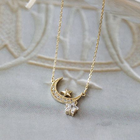 Close-up view of the celestial-themed pendant on the 925 silver necklace, showing the detailed star and moon design.