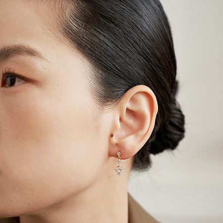 Stylish 18k gold plated cross-shaped earring adorned with small cubic zirconia stones.