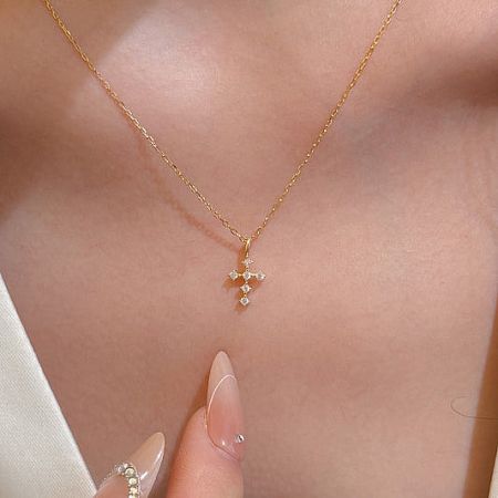 Elegant 14K gold plated cross necklace with CZ stones.
