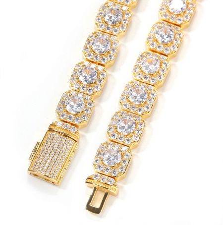 A gold-plated hip hop bracelet with rectangular links fully iced out with clear crystals.