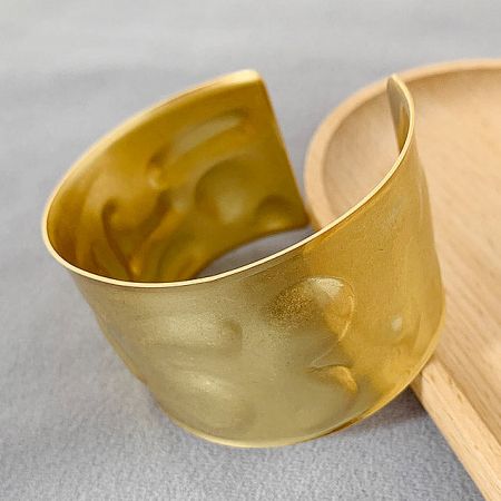 Product shot of the gold Egypt-style cuff bracelet on a white background.
