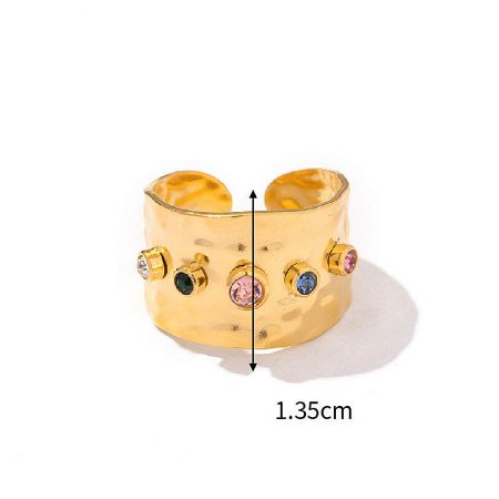 Side view of a gold cuff ring showcasing the hammered texture and gemstone setting.