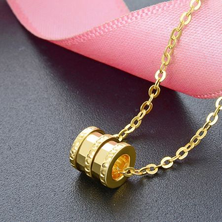 Detailed view of the gold-plated 925 sterling silver lucky tube bead necklace.