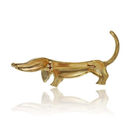 A detailed view of the gold dachshund brooch, highlighting the roller pin catch and fine crystal settings.