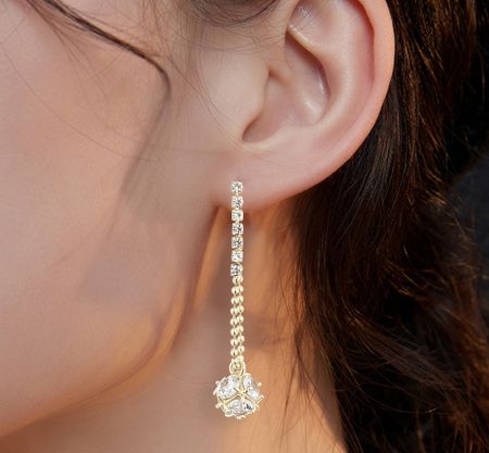 Model wearing the CZ Dice Drop Earrings to show scale and style.