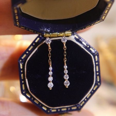 Gold plated version of the CZ chain drop dangle earrings presented in a luxurious blue velvet jewelry box.