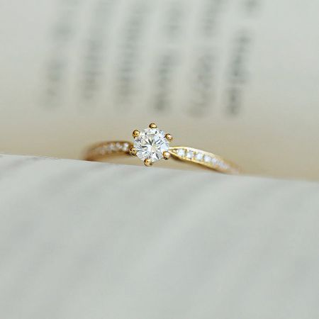 Front view of the gold-plated CZ solitaire ring highlighting its brilliance and classic six-prong setting.