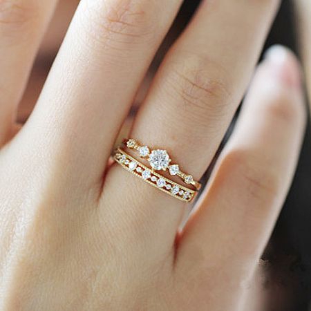 Lifestyle image showing the stacking potential of the gold minimalist rings.