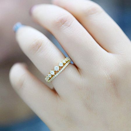 A model wearing the double-row pavé crystal rings on her finger, showcasing their elegant fit.