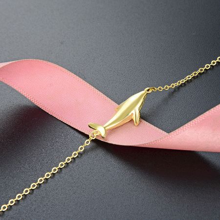 Elegant gold dolphin pendant necklace from the same collection.