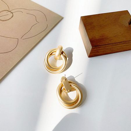 A pair of gold earrings with a double-ring design, perfect for wholesale fashion jewelry.