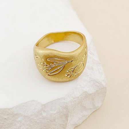 A unique gold brass ring from the set featuring a dragonfly motif.