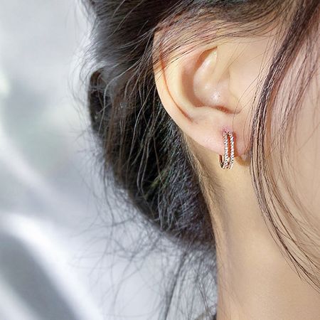 Close-up view of the rhinestone hoop earring on a model's ear, showing its elegant sparkle.