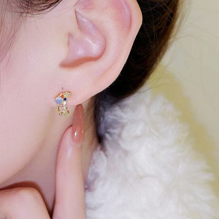 Model wearing one of the colorful stone earrings from the French retro collection.