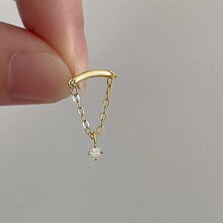 Detailed view of the gold tassel chain earring featuring a delicate diamond-shaped charm.