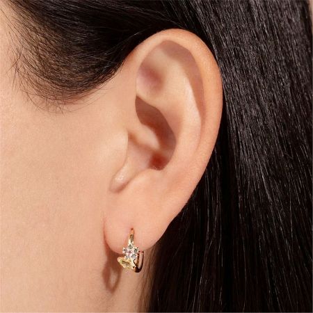 Close-up of the floral hoop earring on a model's ear, showcasing the intricate design.