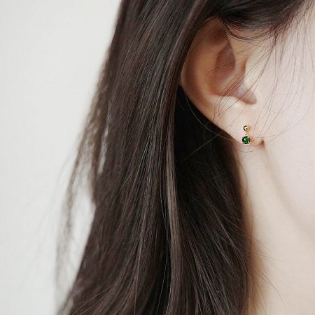 Side profile view of a model wearing the tiny sterling silver jade earring, perfect for everyday elegance.
