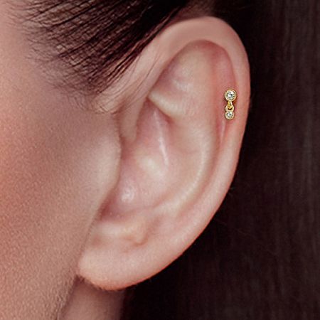 Model showcasing the elegant two-stone CZ stud earring in gold.