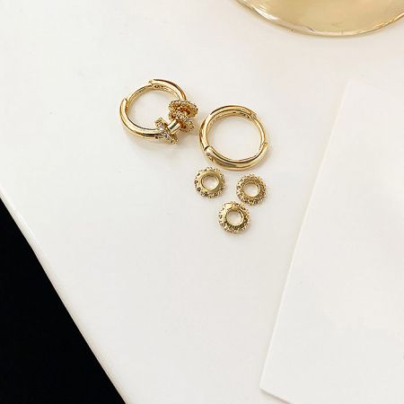 Component view of the gold earrings and related jewelry parts.
