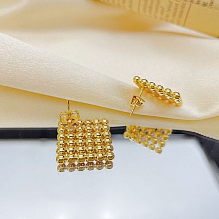 Two different styles from the earring set: a square bead design and a vertical bar bead design.